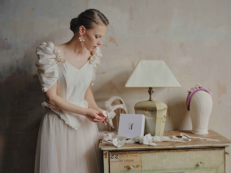 Editorial bridal lookbook featuring a model in a vintage wedding dress with handcrafted floral drop earrings and a matching floral headband, Decoflowers UK.