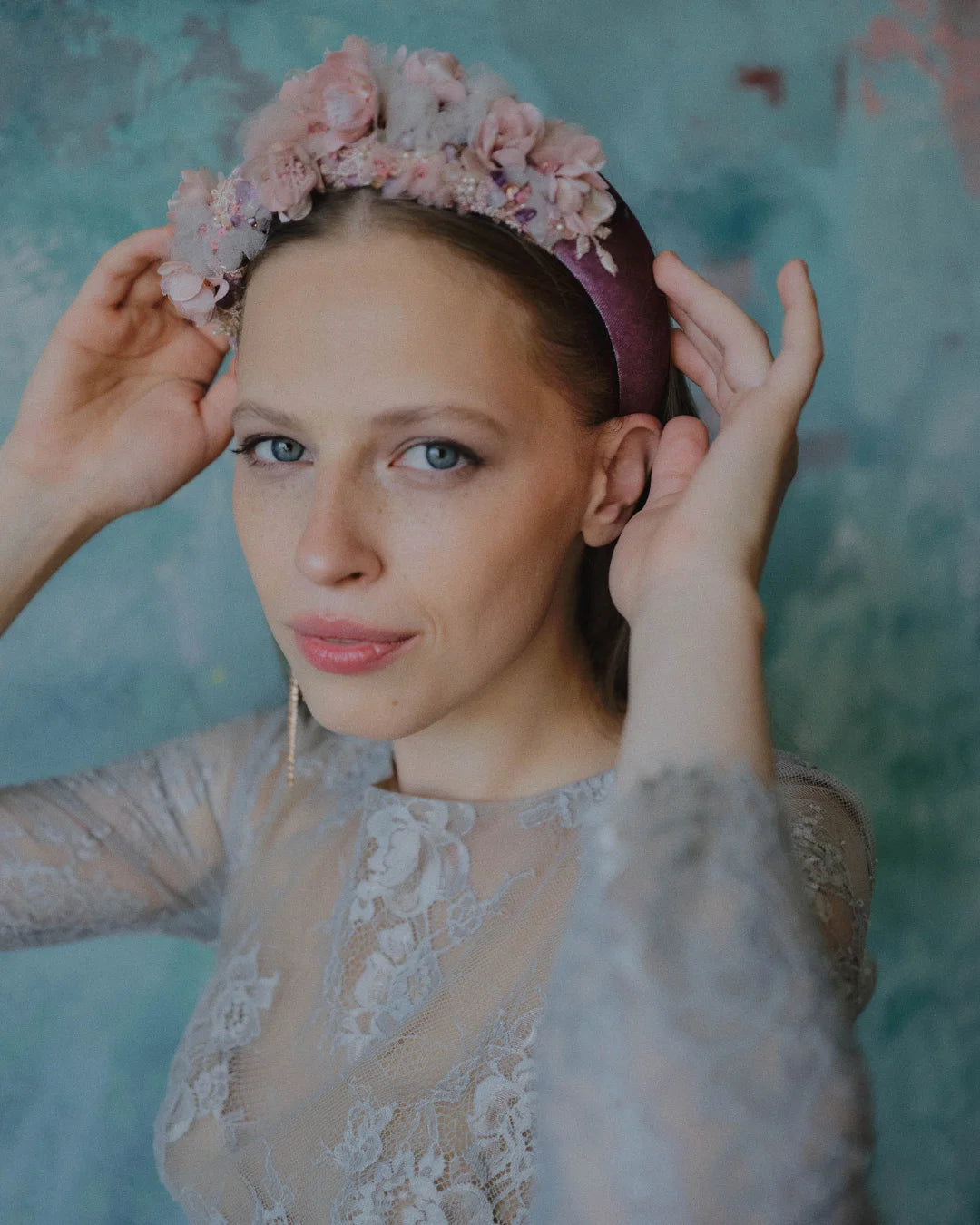 Handmade padded bridal headband with blush pink flowers and crystal embroidery, worn by smiling model.