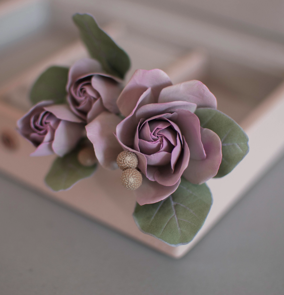 Purple-pink roses with eucalypt leaves and bunias