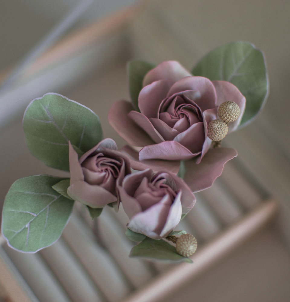 Purple-pink roses with eucalypt leaves and bunias