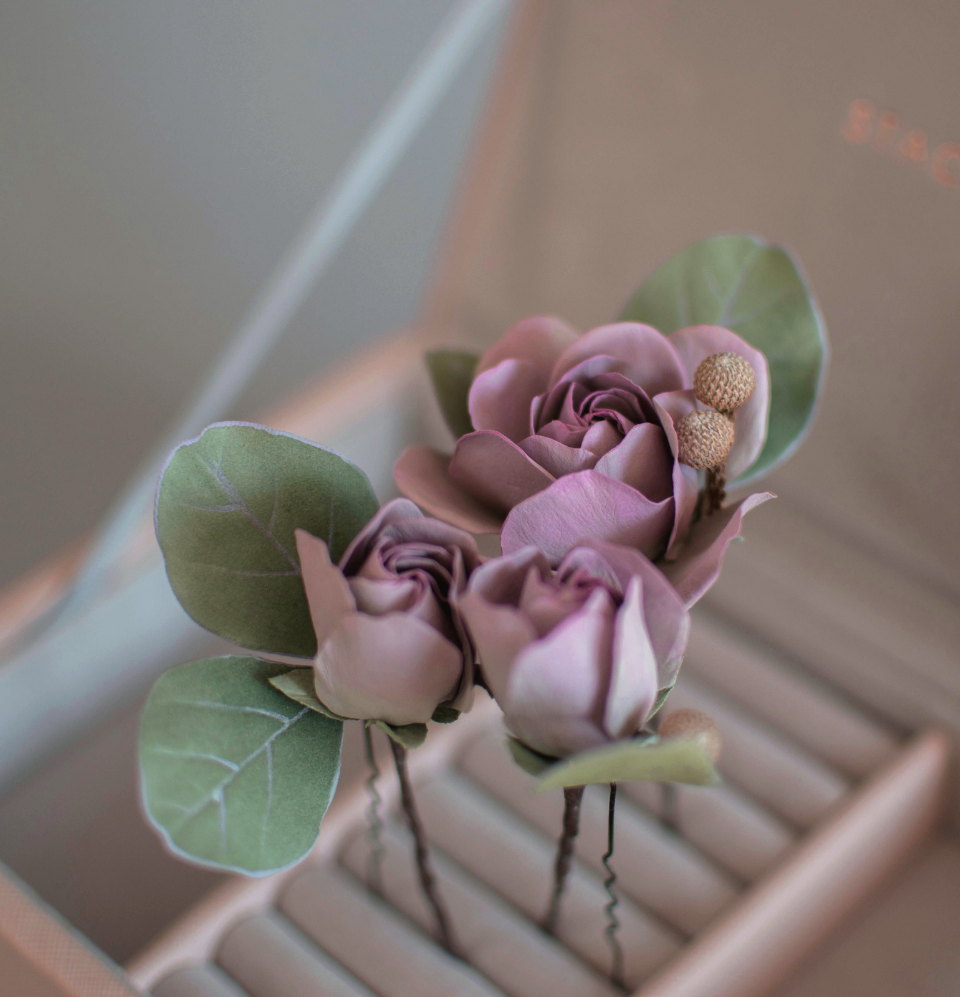Purple-pink roses with eucalypt leaves and bunias
