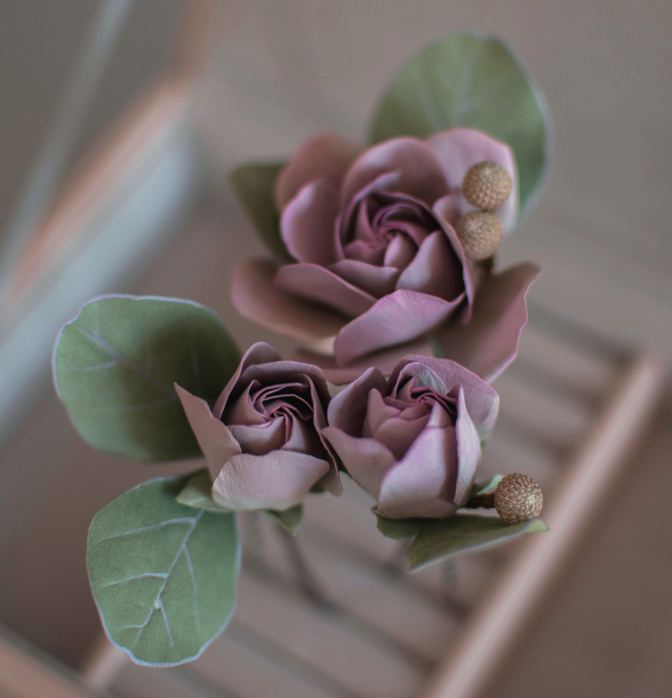 Purple-pink roses with eucalypt leaves and bunias