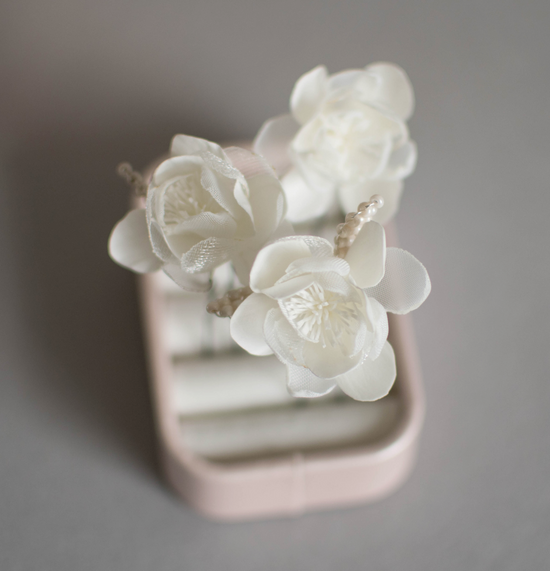Ivory wedding flowers on hair pins