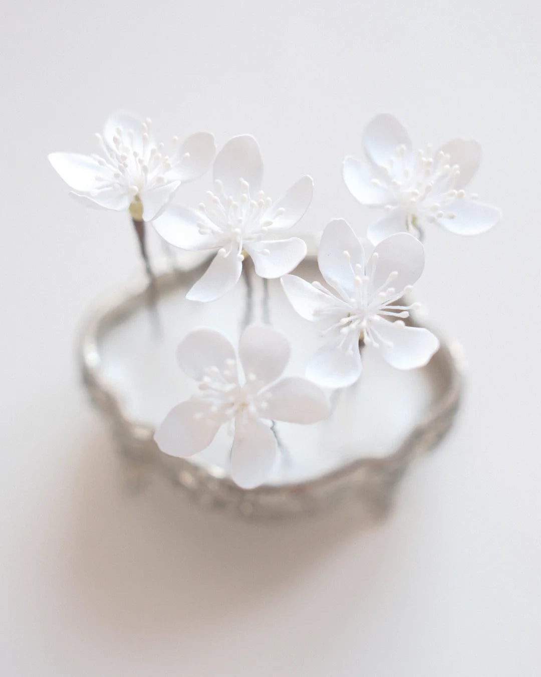 White sakura flower hair pins for a wedding updo