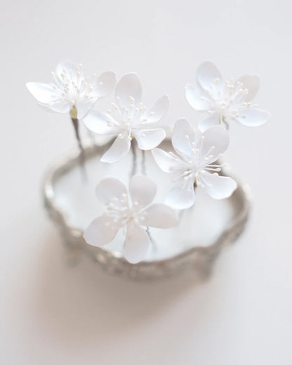 White sakura flower hair pins for a wedding updo
