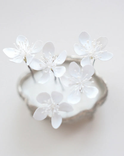Hand-sculpted white cherry blossom hair pin close-up