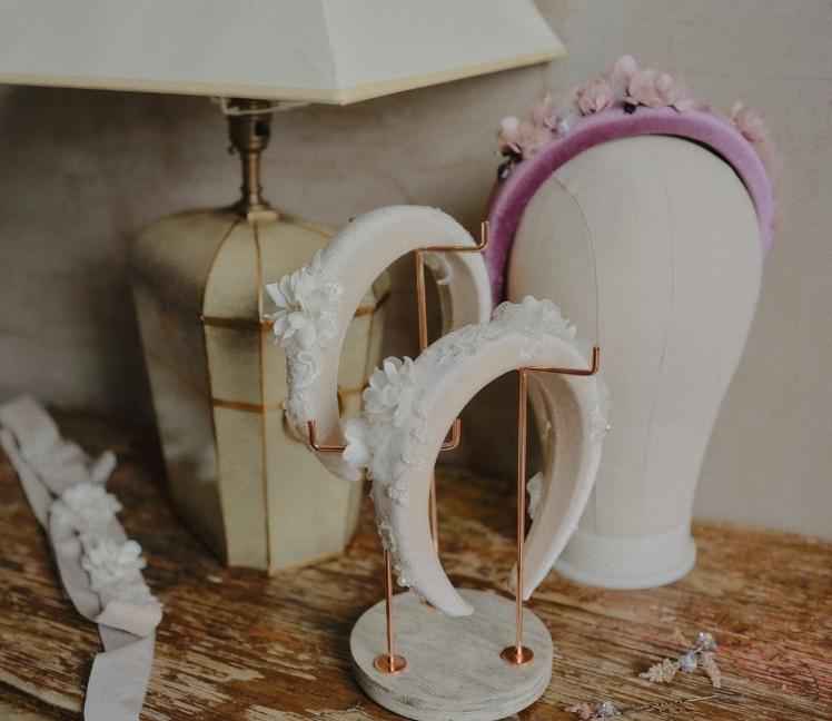 A collection of bespoke handcrafted floral bridal headbands and crowns displayed on mannequin heads, Decoflowers wedding accessories UK.