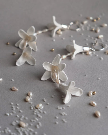 Deco Flowers ‘Hyacinth’ white floral statement bridal earrings with vintage pearls and sterling silver, displayed vertically to show their elegant 11cm drop length.
