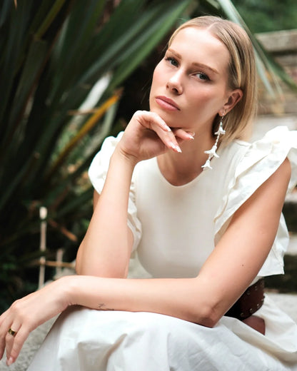 Bridal side profile with 11cm white hyacinth statement earrings.