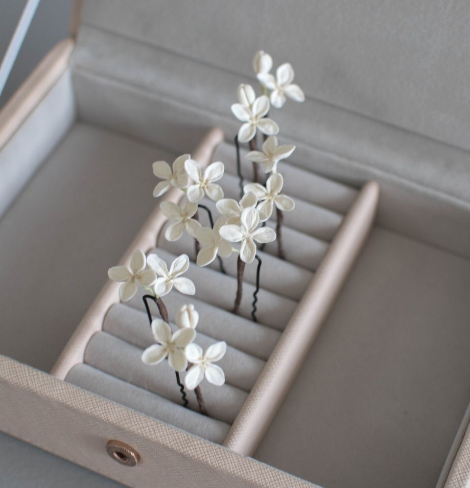 A delicate set of 7 wedding hairpins for the brides with ivory colour small lilac flowers