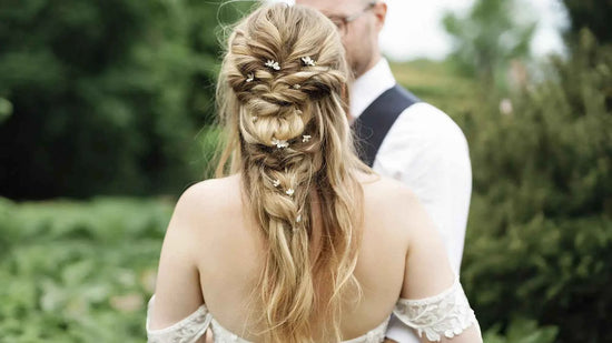 Intricate bridal braided hairstyle decorated with handcrafted tiny white floral hair pins, bespoke wedding hair accessories by Decoflowers UK.