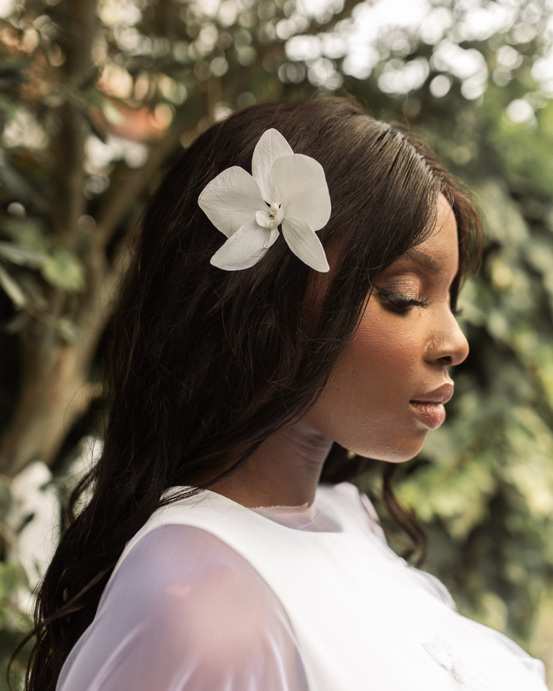 Handmade white orchid bridal hair flower worn as a side accent