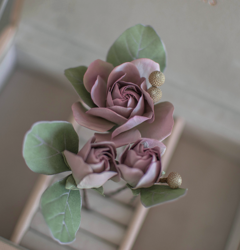 Purple-pink roses with eucalypt leaves and bunias