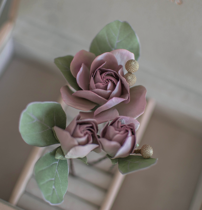 Purple-pink roses with eucalypt leaves and bunias