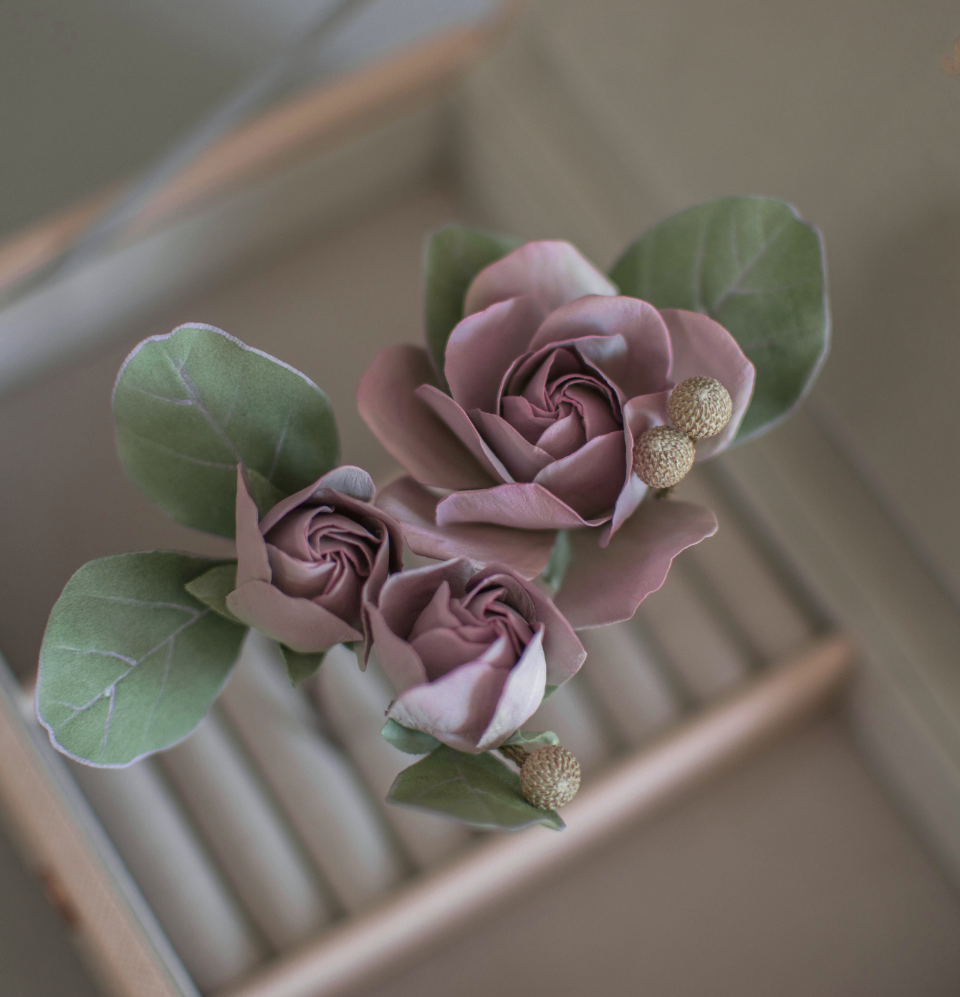 Purple-pink roses with eucalypt leaves and bunias