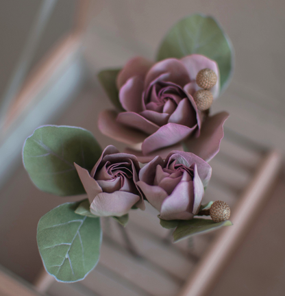 Purple-pink roses with eucalypt leaves and bunias