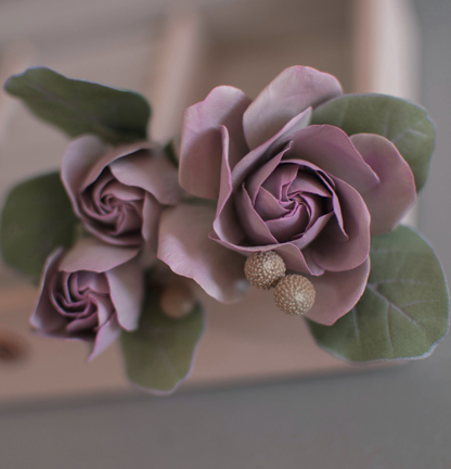 Purple-pink roses with eucalypt leaves and bunias