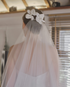Pair of white orchid bridal hair flowers adorning a veil